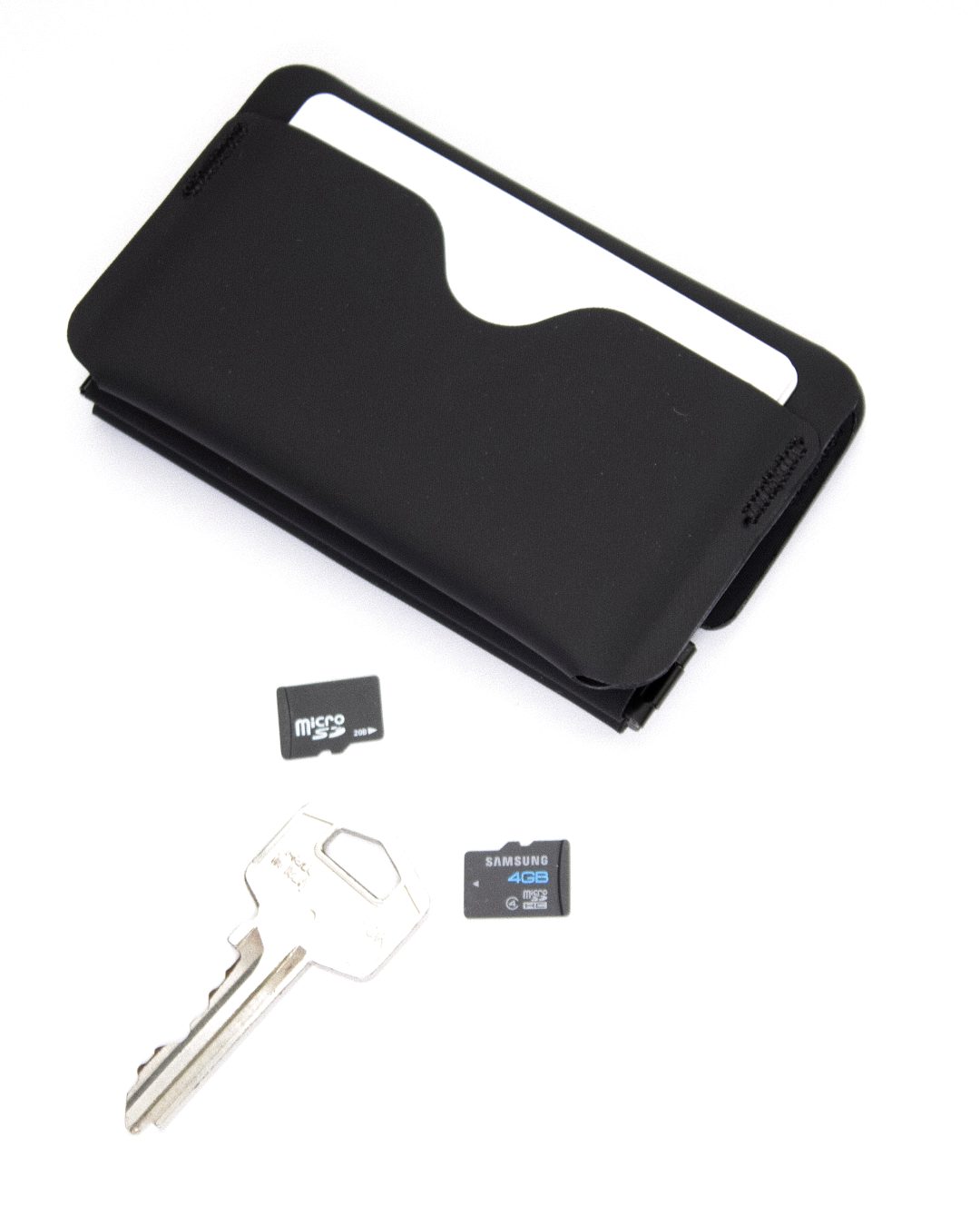 Wallet 01 next to a key and two memory cards
